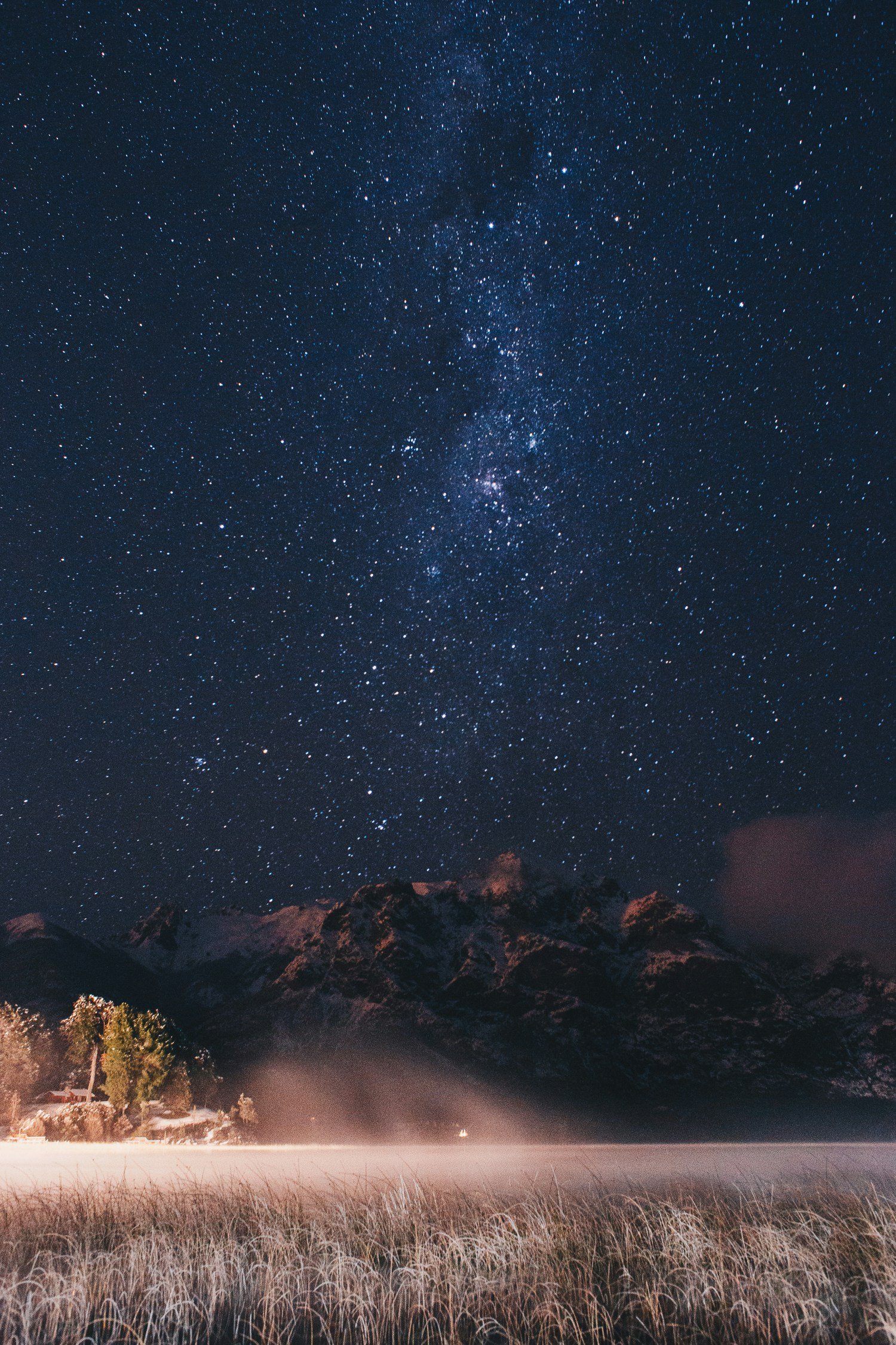 landscape photo of mountains under starry sky at nighttime